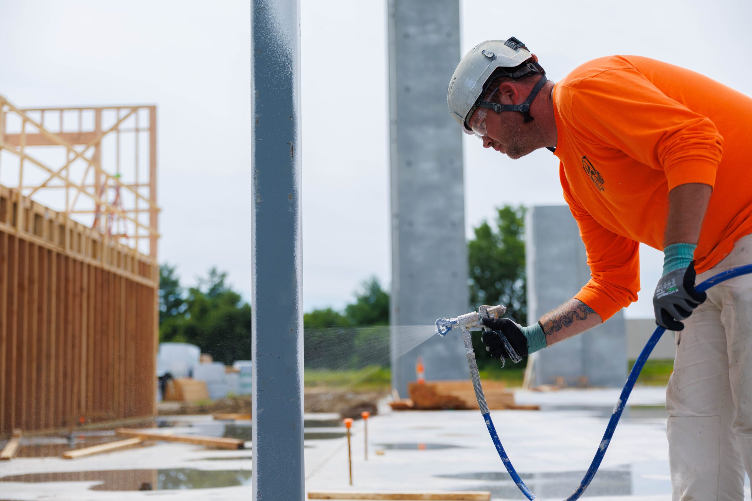 A JC Toland employee sprays intumescent coating