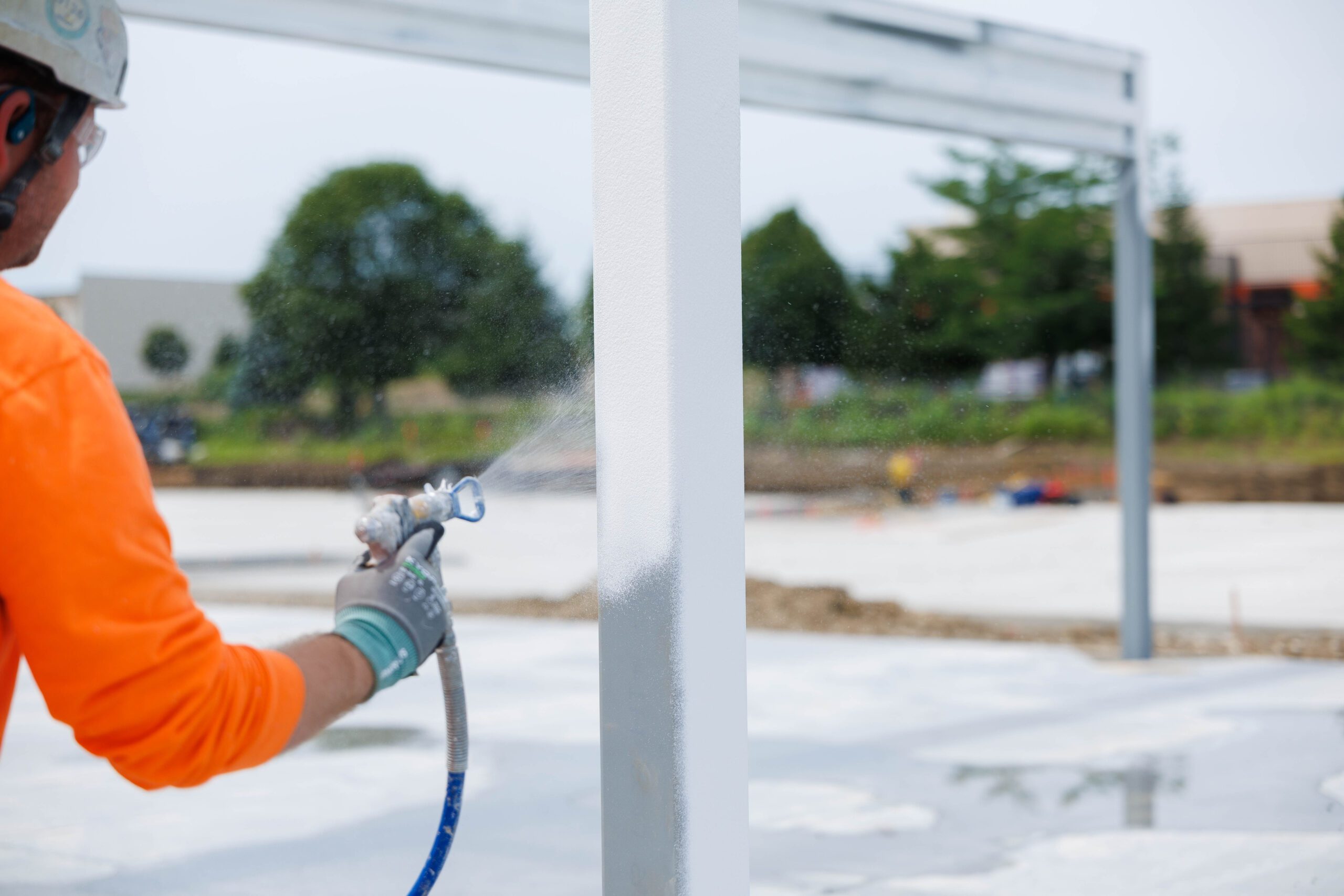 Intumescent coating being applied to structural steel
